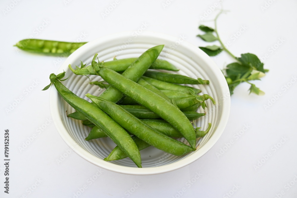Fresh green pea isolated on white background. There is a lot of vitamins and Minerals in it. The pea is most commonly the small spherical seed or the seed. Popular vegetable of all over world. Fresh green pea isolated on white background. There is a lot of vitamins and Minerals in it. The pea is most commonly the small spherical seed or the seed. Popular vegetable of all over world.