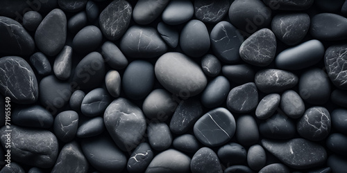 Smooth black pebbles in monochrome texture
