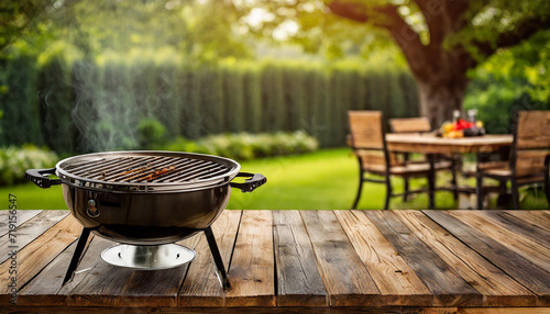 BBq grill in the back yard background with empty wooden table