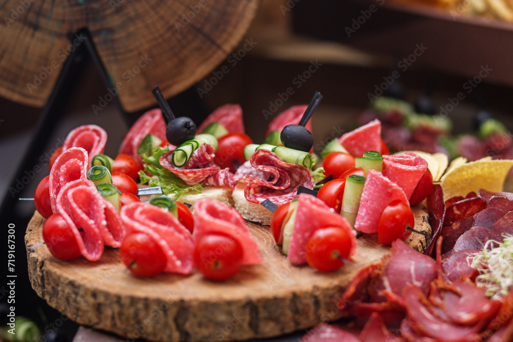 Food at event. Assorted Canapés on Rustic Wooden Platter