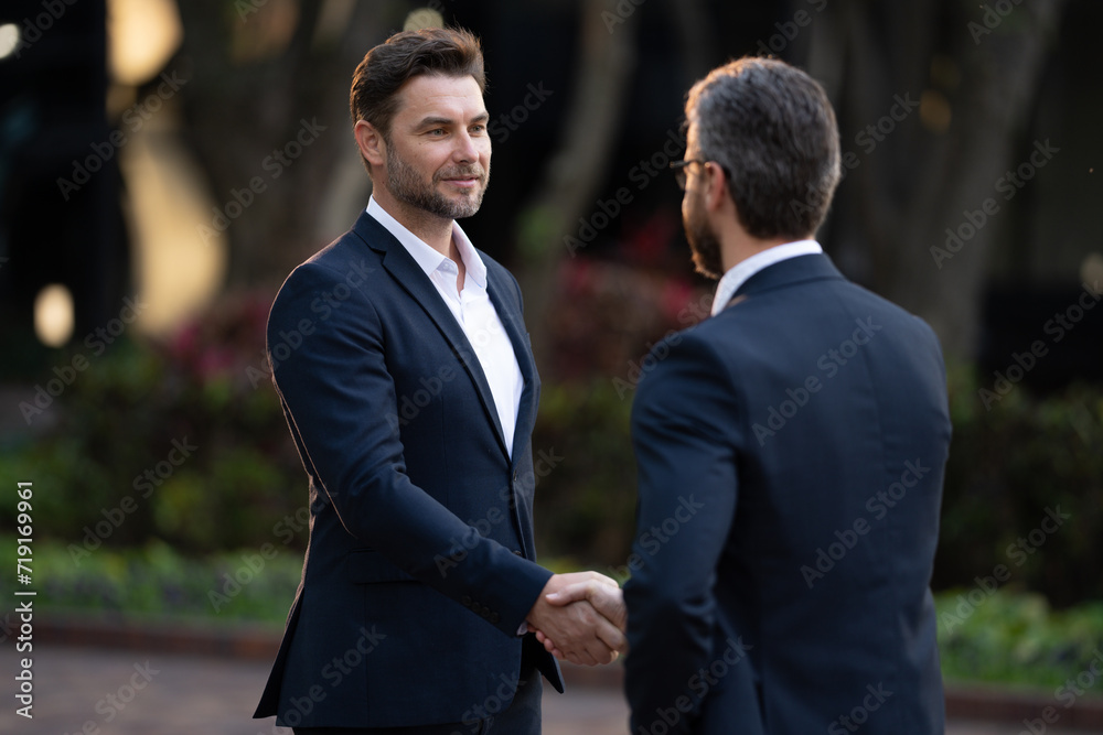 Businessman handshake for teamwork ,successful. Business network concept. Management strategy. Human resources. businessman greeting and making handshake with a businessman outdoors in city walkway. Businessman handshake for teamwork ,successful. Business network concept. Management strategy. Human resources. businessman greeting and making handshake with a businessman outdoors in city walkway.