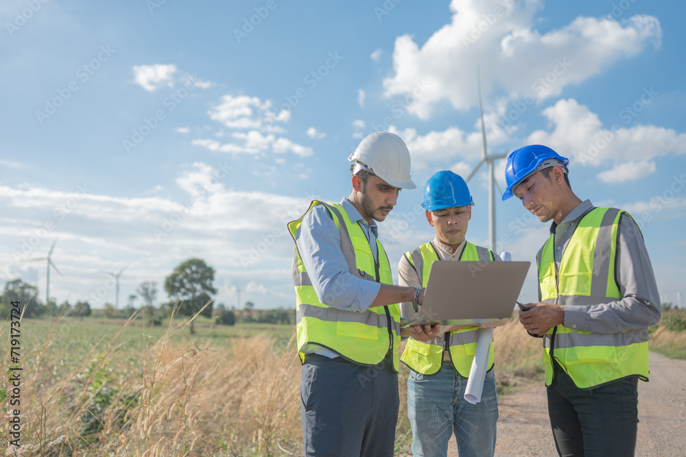 Asian engineers working in fieldwork outdoor. Workers walking and inspect construction and machine around project site. Wind turbine electrical of clean resource enerdy and environment sustainable. Asian engineers working in fieldwork outdoor. Workers walking and inspect construction and machine around project site. Wind turbine electrical of clean resource enerdy and environment sustainable.
