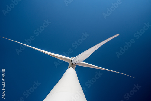 Asian engineers working in fieldwork outdoor. Workers check and inspect construction and machine around building project site. Wind turbine for electrical of clean energy and environment sustainable. photo