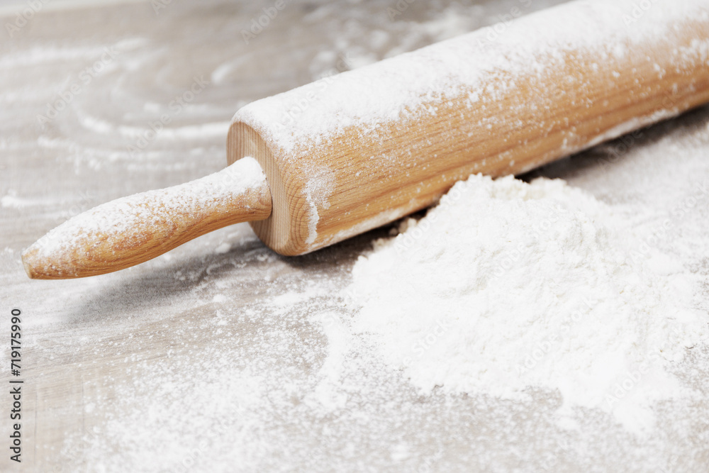 Flour and rolling pin on a wooden table Flour and rolling pin on a wooden table