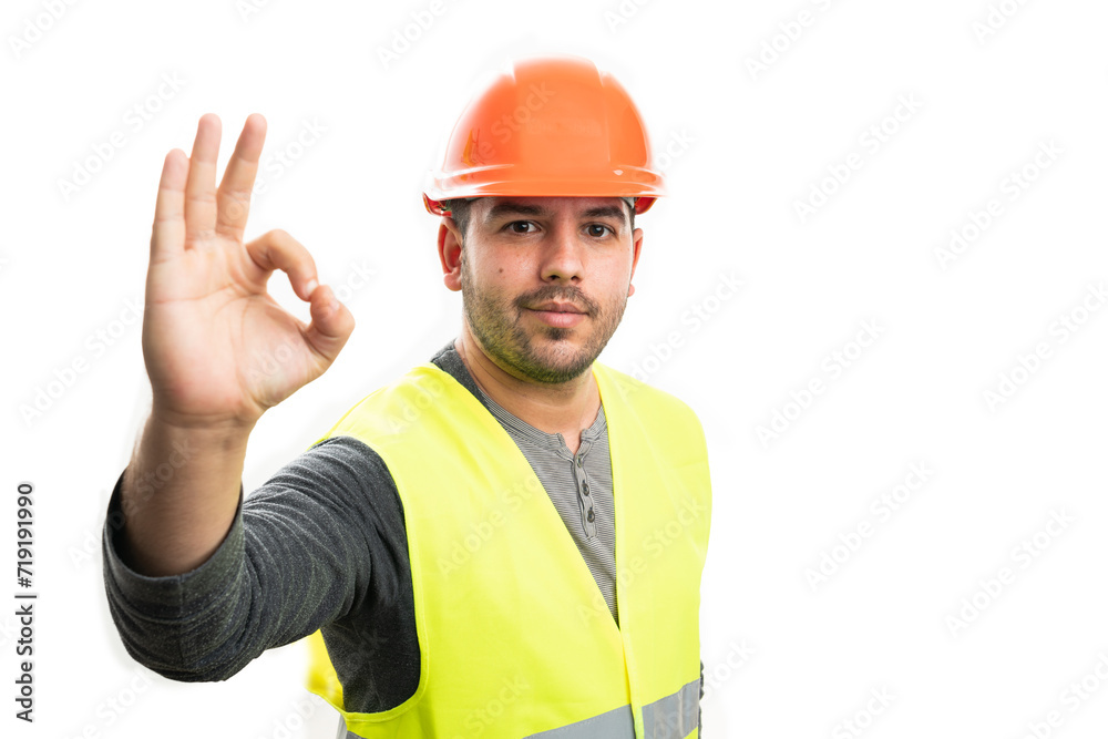 Builder man with friendly expression showing okay gesture Builder man with friendly expression showing okay gesture