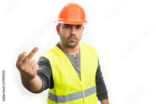 Angry builder man showing offensive middle finger gesture