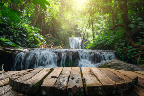 Wood table top podium floor in outdoor waterfall green tropical forest nature background. photo