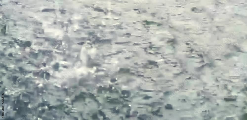 splashing water that occurs when rainwater falls on a puddle splashing water that occurs when rainwater falls on a puddle