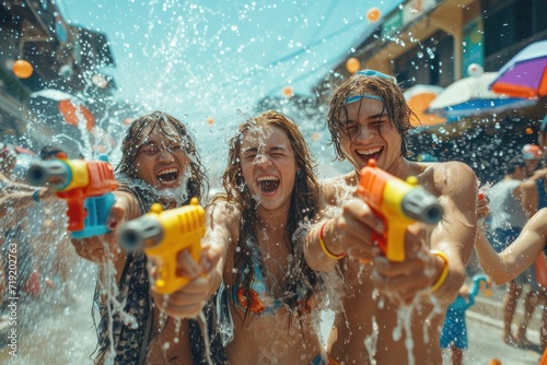 A group of tourists and foreign friends play in the water in Thailand on Songkran Celebrate Songkran Festival holding a colorful water gun.