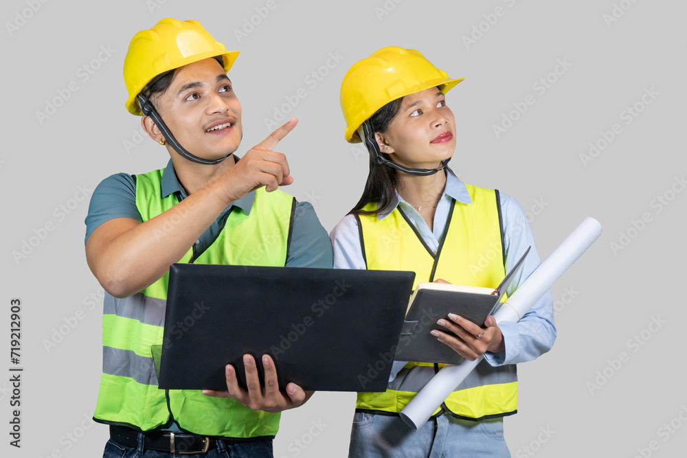 Asian Couple Engineer & Architect gives gestures and expressions on construction field with laptop Asian Couple Engineer & Architect gives gestures and expressions on construction field with laptop