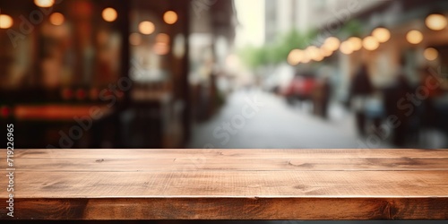Empty brown wooden table with blurred coffee shop background, perfect for photomontage or product display. © Sona