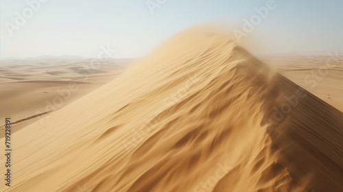 Strong winds blow the sand off the top of the dune