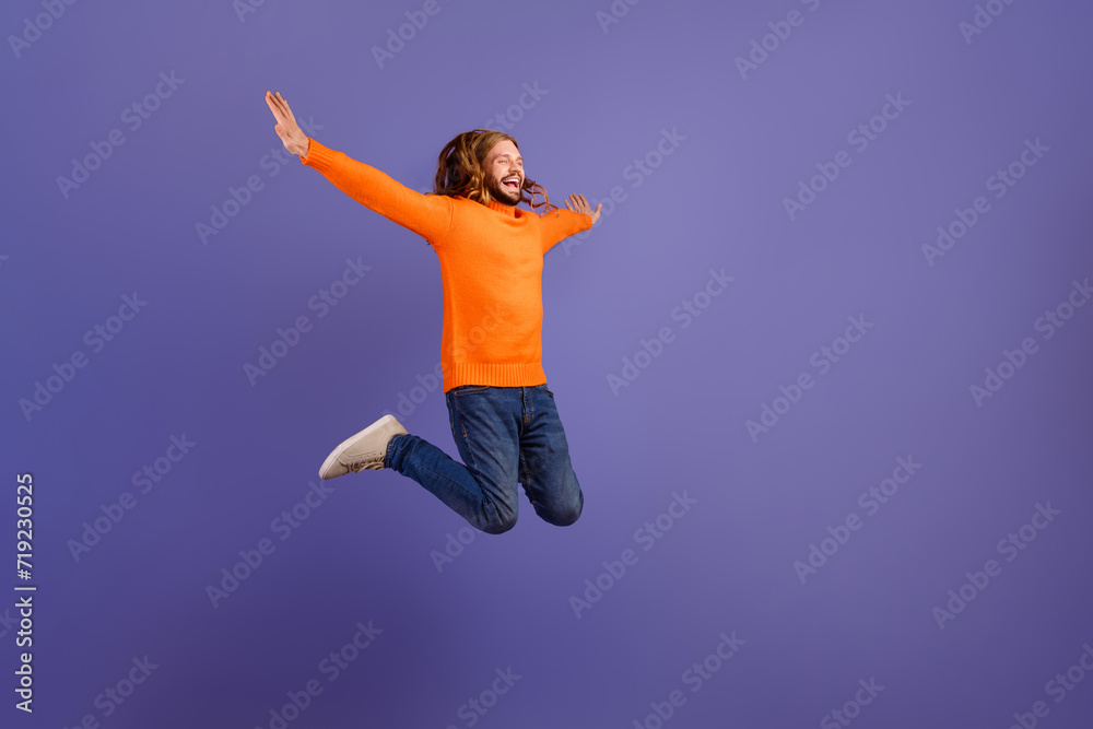 Full body length photo of young funny positive man hipster carefree catch freedom flying in air wings isolated on violet color background