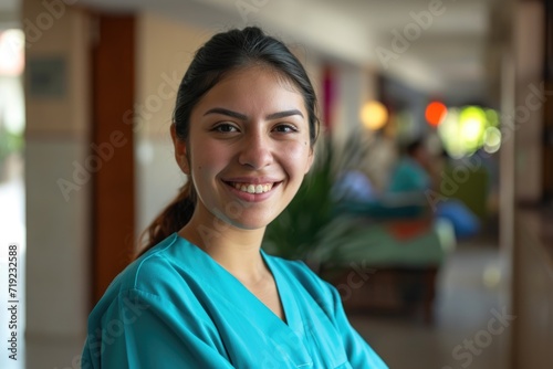 Portrait of young nurse in scrubs at nursing home
