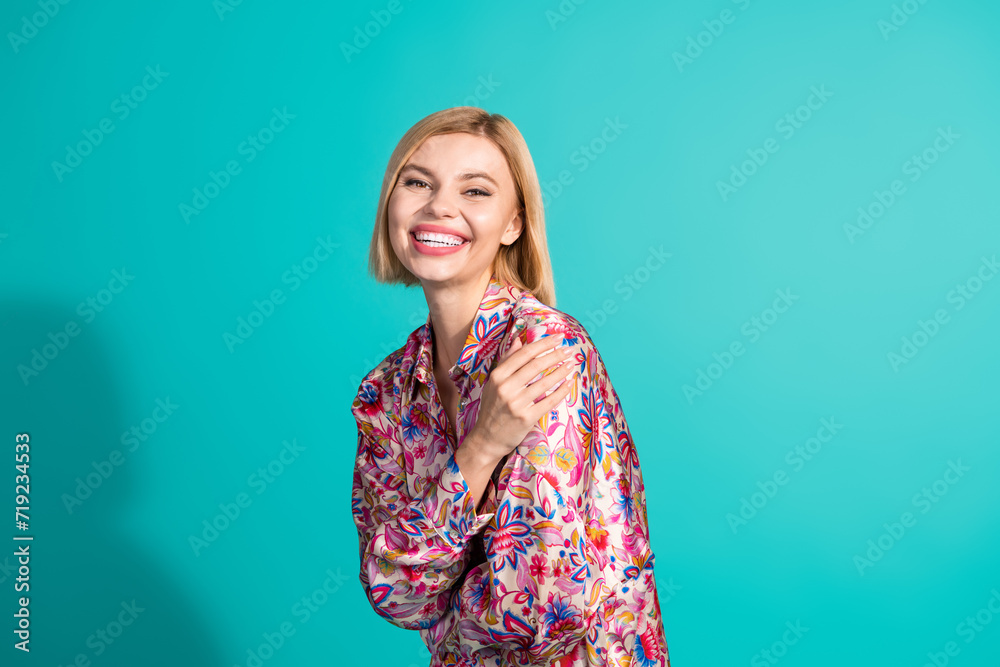 Fototapeta premium Portrait of satisfied cheerful pretty girl wear oversize shirt cuddle herself enjoy fresh clothes isolated on turquoise color background