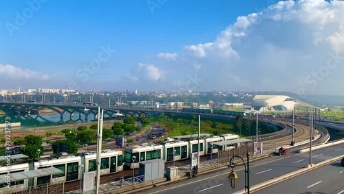 4K video of Modern tram passing by the Bou Regreg river and Scenic view of old city of oudaya with a view over the Grand Theatre of the capital city of Morocco, RABAT photo