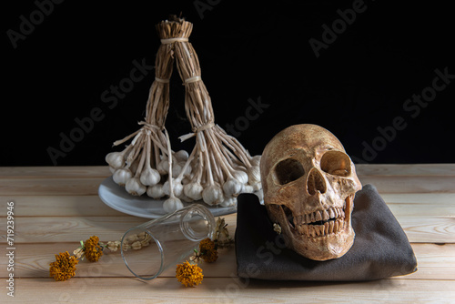skulls , decorative dried herbs and a skeletal head, perfect for Halloween or medical-themed design