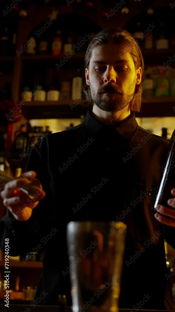 Attentive Bartender with Cocktail and Bottle Attentive Bartender with Cocktail and Bottle