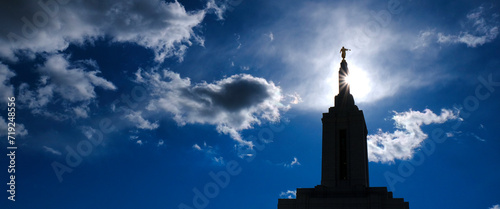 Angel Moroni on Top of Mormon LDS Temple with Sky and Clouds Sunstar Bright Holy Light