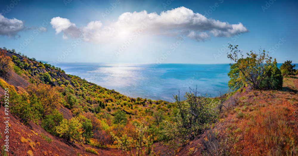 Green bushes on the edge of cliff. Sunny summer scene of Crimean Mountains. Aerial seascape of Black sea. Panoramic morning view of seashore. Beauty of nature concept background,