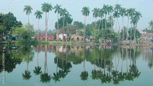 Amazing lake and palm trees landskape with reflection in Puthia Bangladesh photo