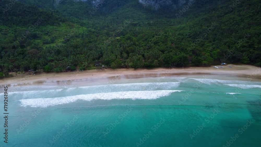 Aerial view of Nagtabon Beach in Palawan Philippines following heavy rains. stormy clouds and waves lapping onto the beach. Aerial view of Nagtabon Beach in Palawan Philippines following heavy rains. stormy clouds and waves lapping onto the beach.