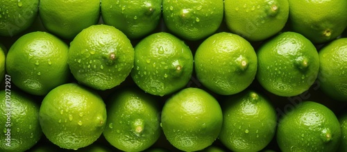 At the market, a stack of neatly arranged lime halves catches the eye, promising a burst of tangy flavor with its vibrant and inviting display.