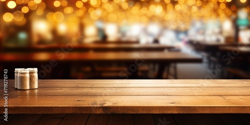 Wooden table in cafe with blurred golden bokeh