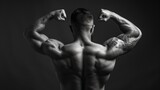 Strength Defined: Muscular Tattooed Man Flexing His Powerful Back Muscles