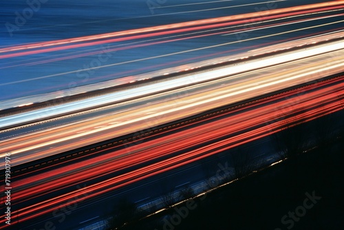 Lights of moving cars at night, long exposure, light trails on the road
