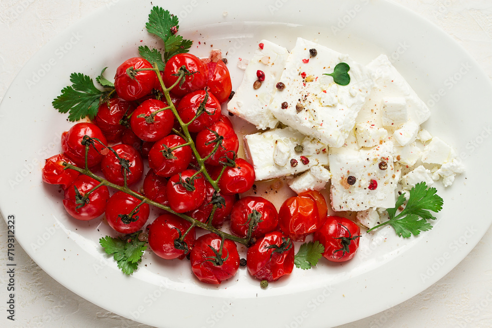 baked cherry tomatoes , with cheese, and spices, on a white plate, homemade, no people, baked cherry tomatoes , with cheese, and spices, on a white plate, homemade, no people,