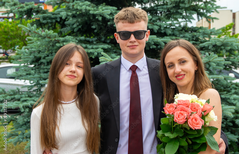 A mother with flowers and a daughter with her son. A mother with flowers and a daughter with her son.