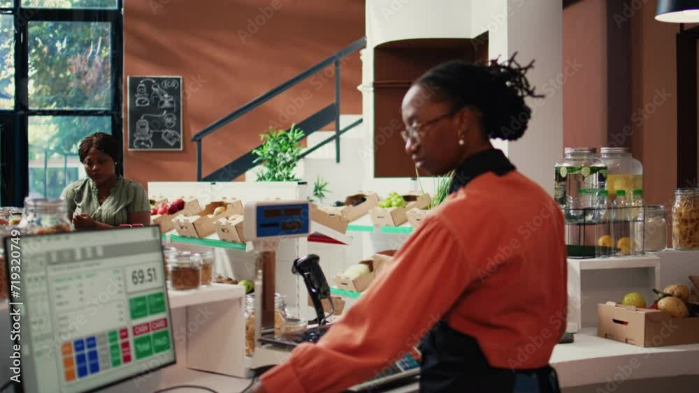 Retailer scanning products and using scale at checkout, serving regular