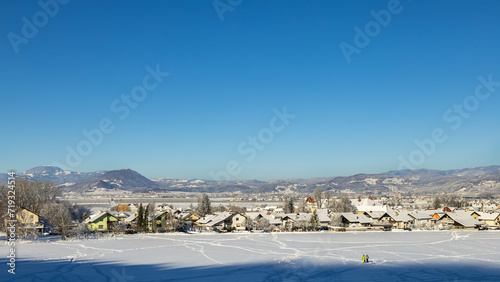 Winter landscape, mountains and trees in the snow, the sun is shining brightly.