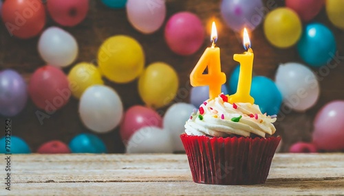 Birthday cupcake with burning lit candle with number 41. Number fortyone for fortyone years or fortyfirst anniversary. photo