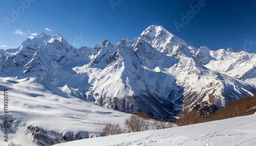 snowy greater caucasus ridge with the mt ushba at winter sunny day view from pastuchova kliffs at elbrus ski slope kabardino balkaria russia photo