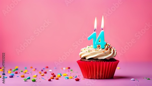 Birthday cupcake with burning lit candle with number 14. Number fourteen for fourteen years or fourteenth anniversary.