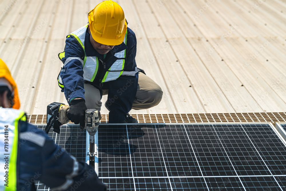Worker Technicians are working to construct solar panels system on roof with sky and clound on background. Installing solar photovoltaic panel system. Renewable clean energy technology concept. Worker Technicians are working to construct solar panels system on roof with sky and clound on background. Installing solar photovoltaic panel system. Renewable clean energy technology concept.