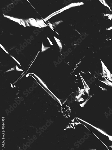 Wrinkled plastic wrap texture on a black background