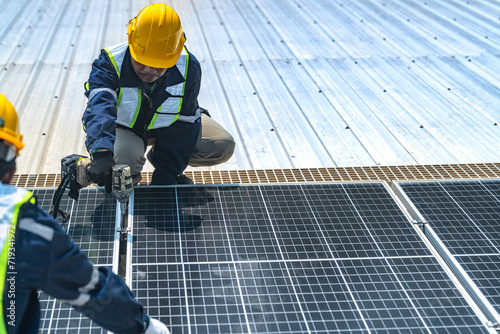 Worker Technicians are working to construct solar panels system on roof with sky and clound on background. Installing solar photovoltaic panel system. Renewable clean energy technology concept.