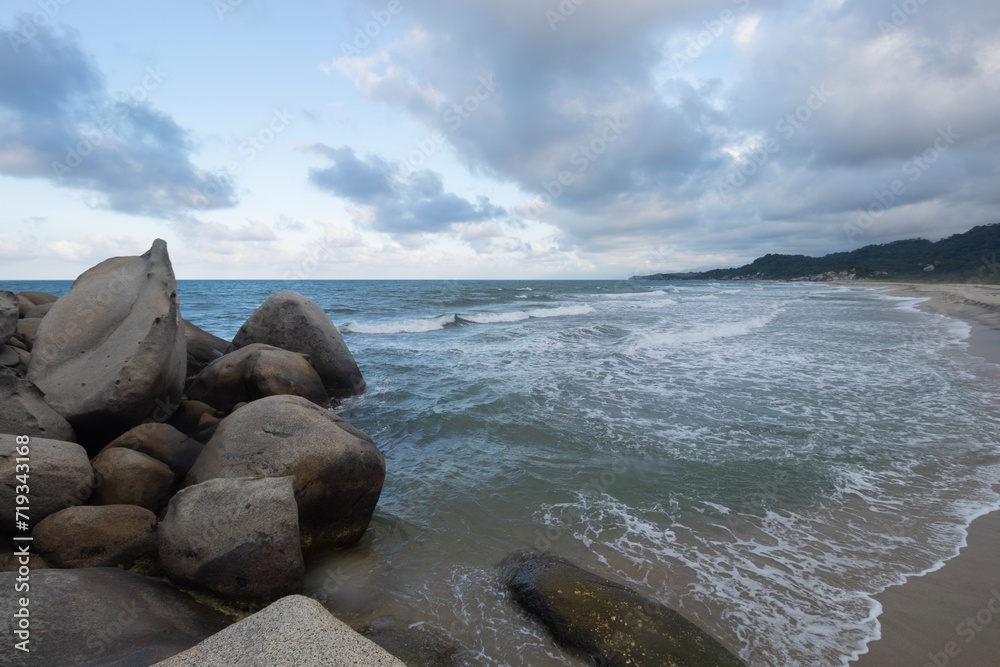 Beautiful shore big rocks with blue caribbean sea in blue dawn beach landscape