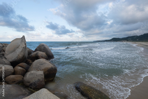 Beautiful shore big rocks with blue caribbean sea in blue dawn beach landscape