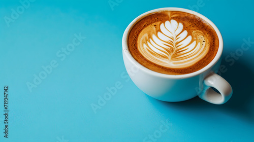 Hot Coffee latte with latte art in a ceramic white cup isolated on soft blue background, top side view. copy space, mock up product.