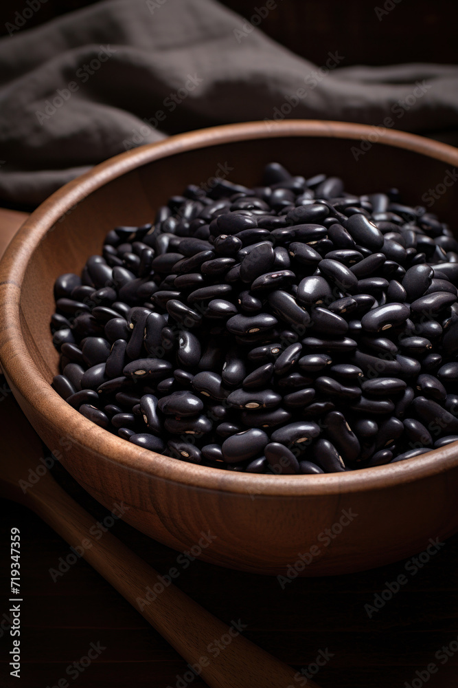 Dry black bean in wooden bowl. Dry black bean in wooden bowl.