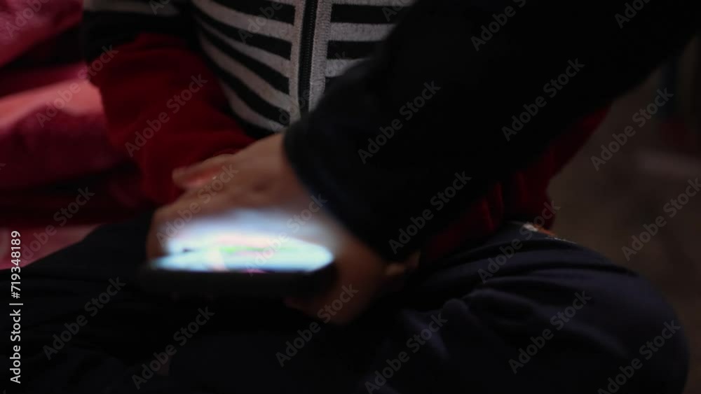 child finger tapping mobile phone screen at home at night from different angle child finger tapping mobile phone screen at home at night from different angle