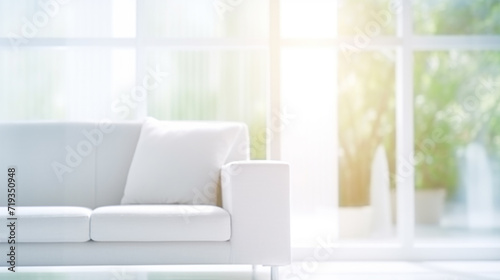 Abstract blur of a white sofa in a sun-drenched modern living room.