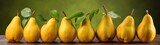 The image shows a row of eight yellow pears with green leaves on a rustic wooden table with a blurred green background.