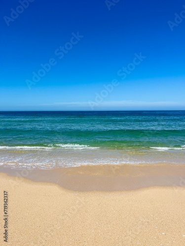 Blue seascape  sandy sea coastline  empty wild beach  pure blue sky  sea horizon