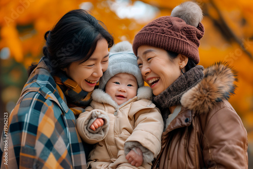 Two Women asians and a Baby Smiling for the Camera