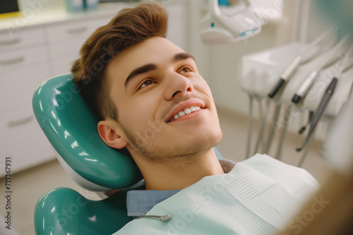 a photo of a handsome adult man client patient at a dental clinic. cleaning and repairing teeth at a dentist doctor. laying on the orthodontic dental chair